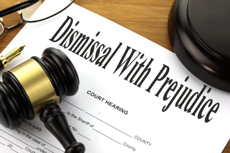 Legal gavel and court documents explaining dismissed with prejudice meaning and its significance for lawsuit outcomes